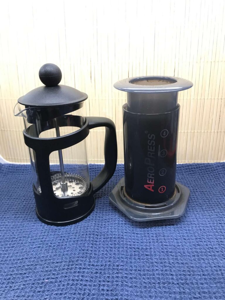 A French press and an AeroPress stood side by side.