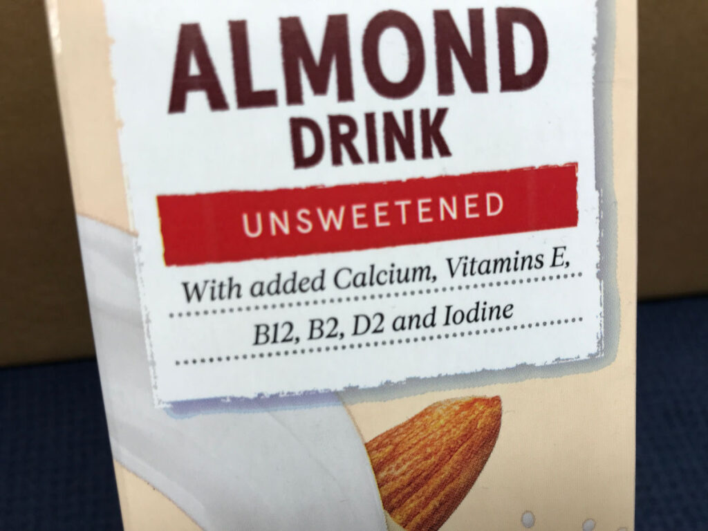 Close-up of a carton of almond milk. One of the beat non-dairy milks for lattes and other coffees.