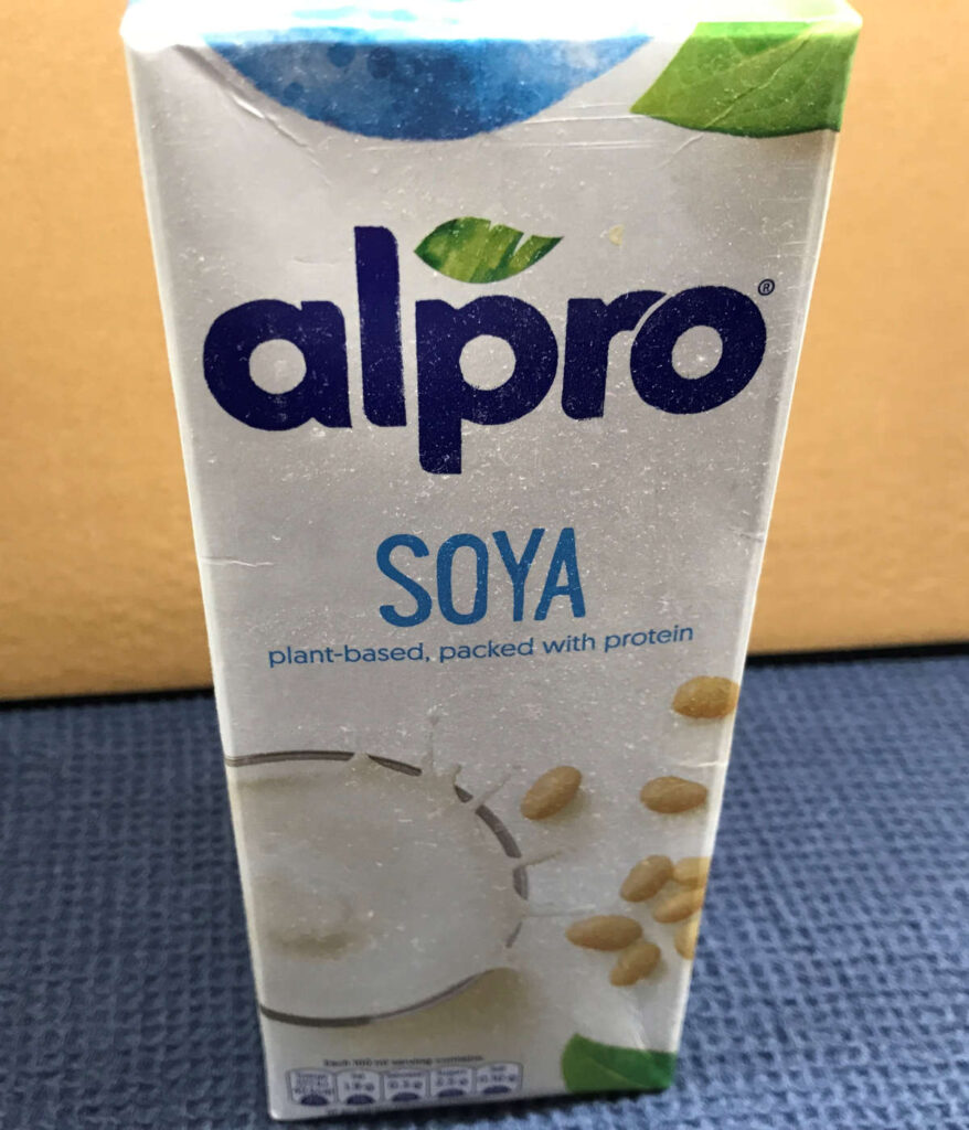 A carton of chilled soy milk. One of the best non-dairy milks for coffee.