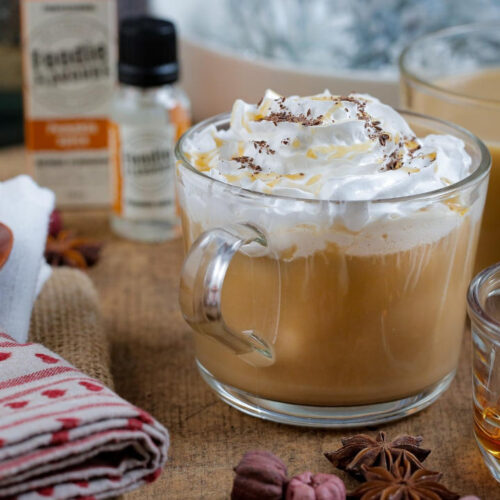 A refreshing luxurious iced pumpkin spice latte topped with whipped cream and a dusting of chocolate.