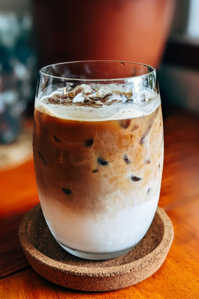 A cool and refreshing iced pumpkin spice latte in a glass.