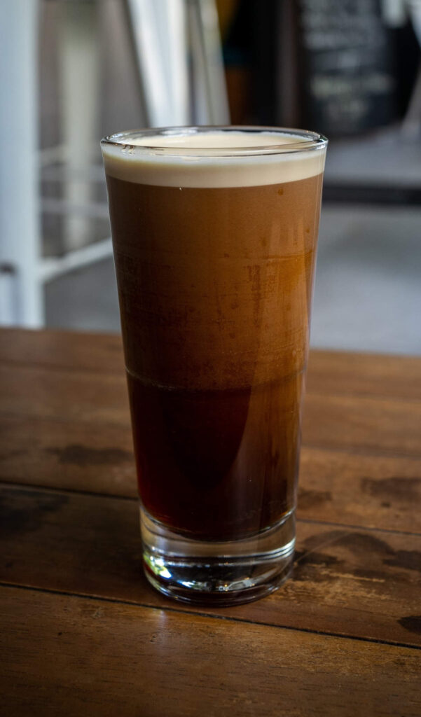A tall glass of nitro cold brew coffee